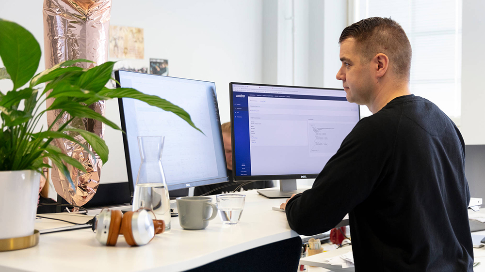 man working at computer with two screens