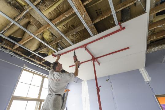 Construction worker fixing a roof