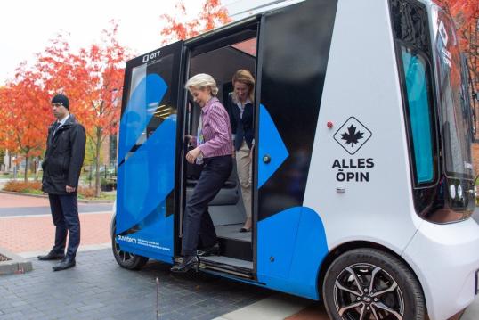 Commission President Ursula von der Leyen stepping of an autonomous hydrogen powered minibus