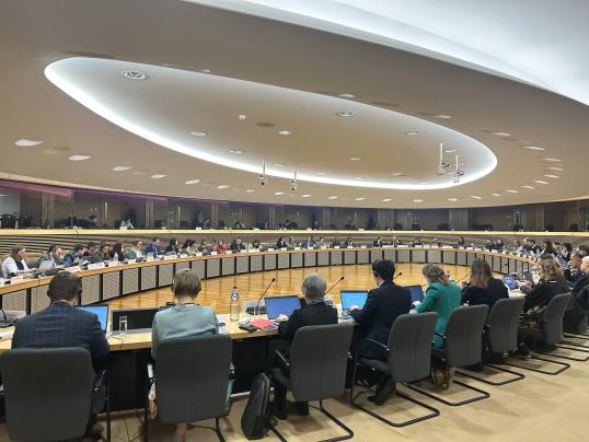 picture of the conference with many people sit at a round table