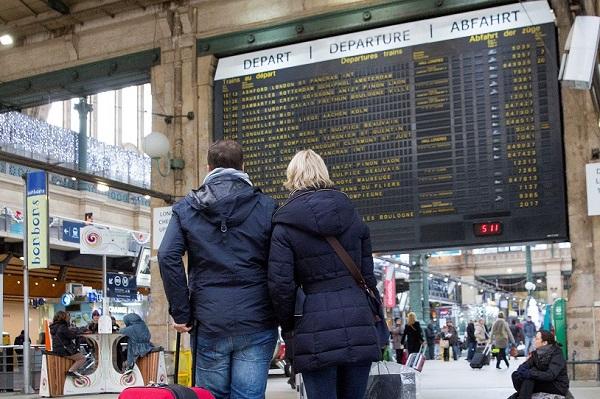 two people with luggage at the train station