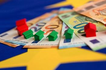 Euro bank notes with plastic miniature houses