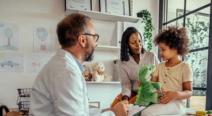 Doctor assessing a child and mother