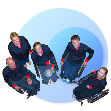 five people in wheelchairs looking up 