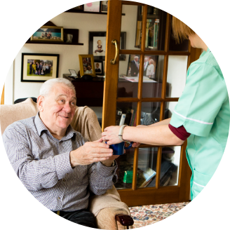Long-term care for elderly people: a carer looking after an older man in his home