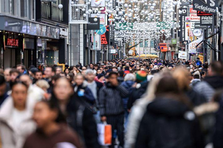 People walking down a pedestrian street in Cologne