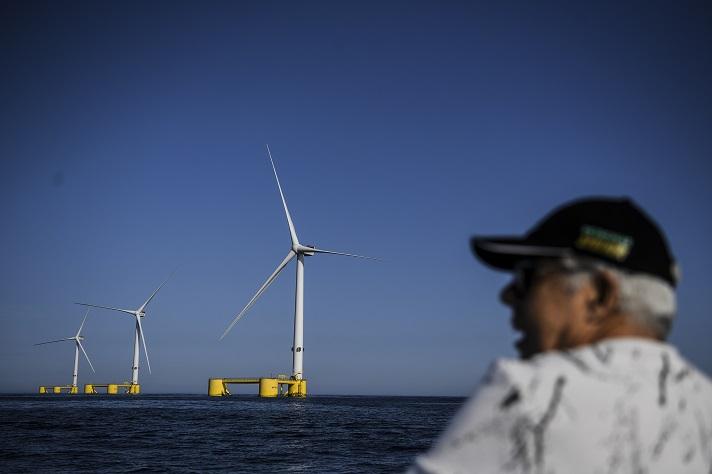 Offshore windmills with man in foreground