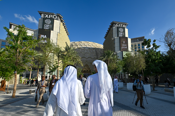 Two men arriving at the COP28 conference center