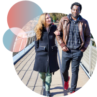 mixed race couple walking in a bridge