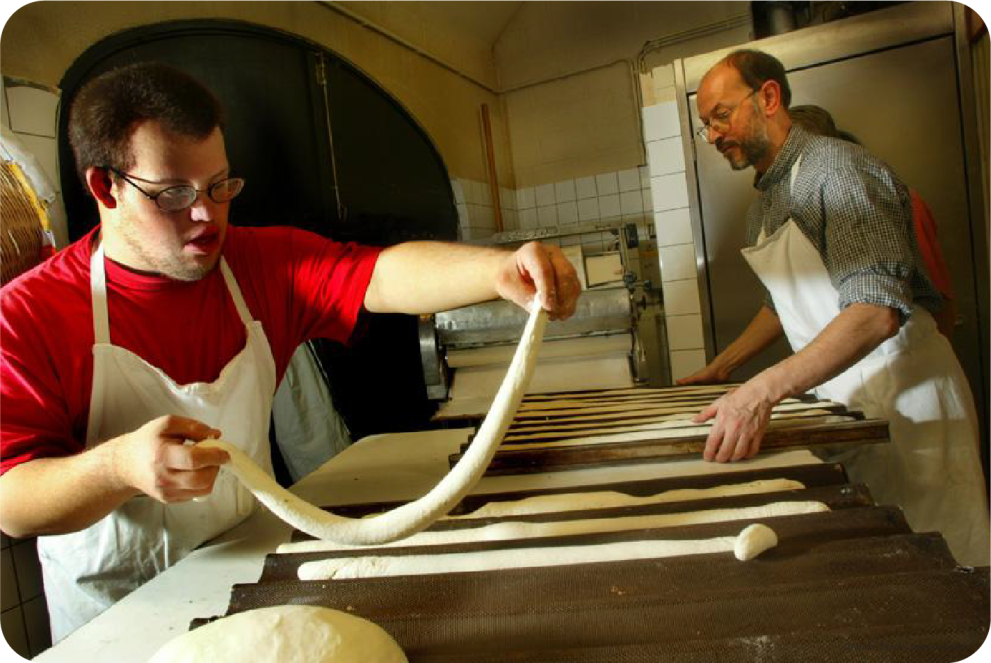 two persons with disabilities making bread