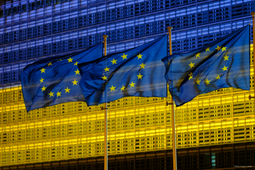 EU flags infront of Berlaymont lit with Ukraine colours