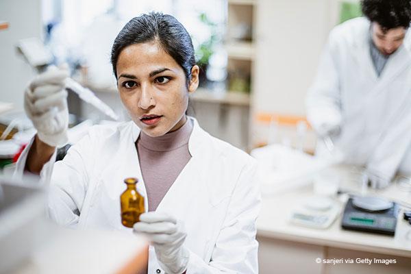 Woman scientist in labcoat in laboratory