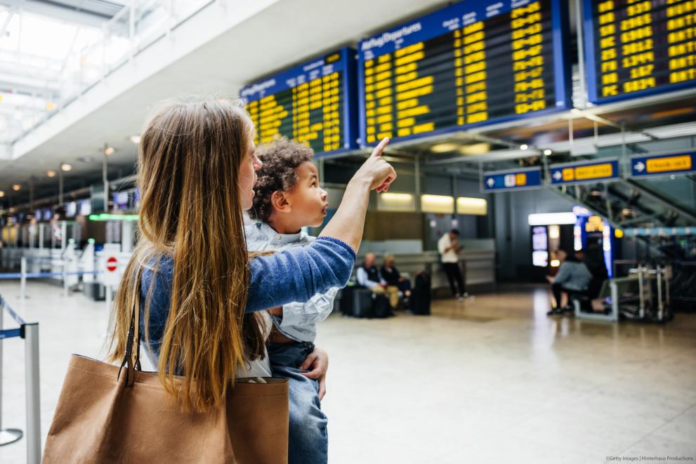 Mother and child looking in the airport departure lounge
