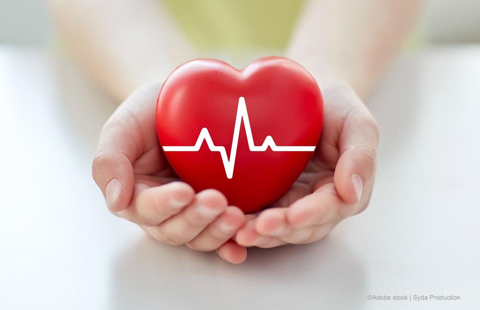 close-up-of-hand-with-cardiogram-on-red-heart