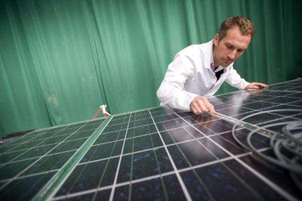 an employee working on a solar panel
