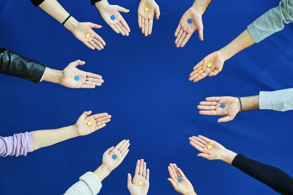 Hands in circle with EU stars