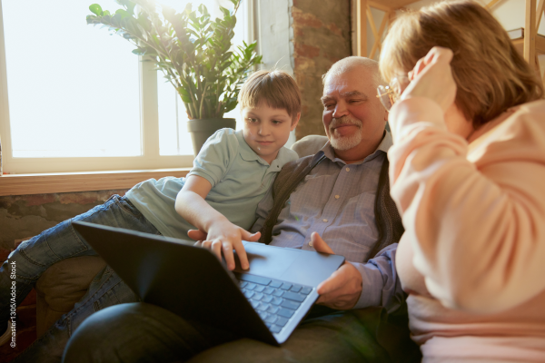 grandparents with child using a computer